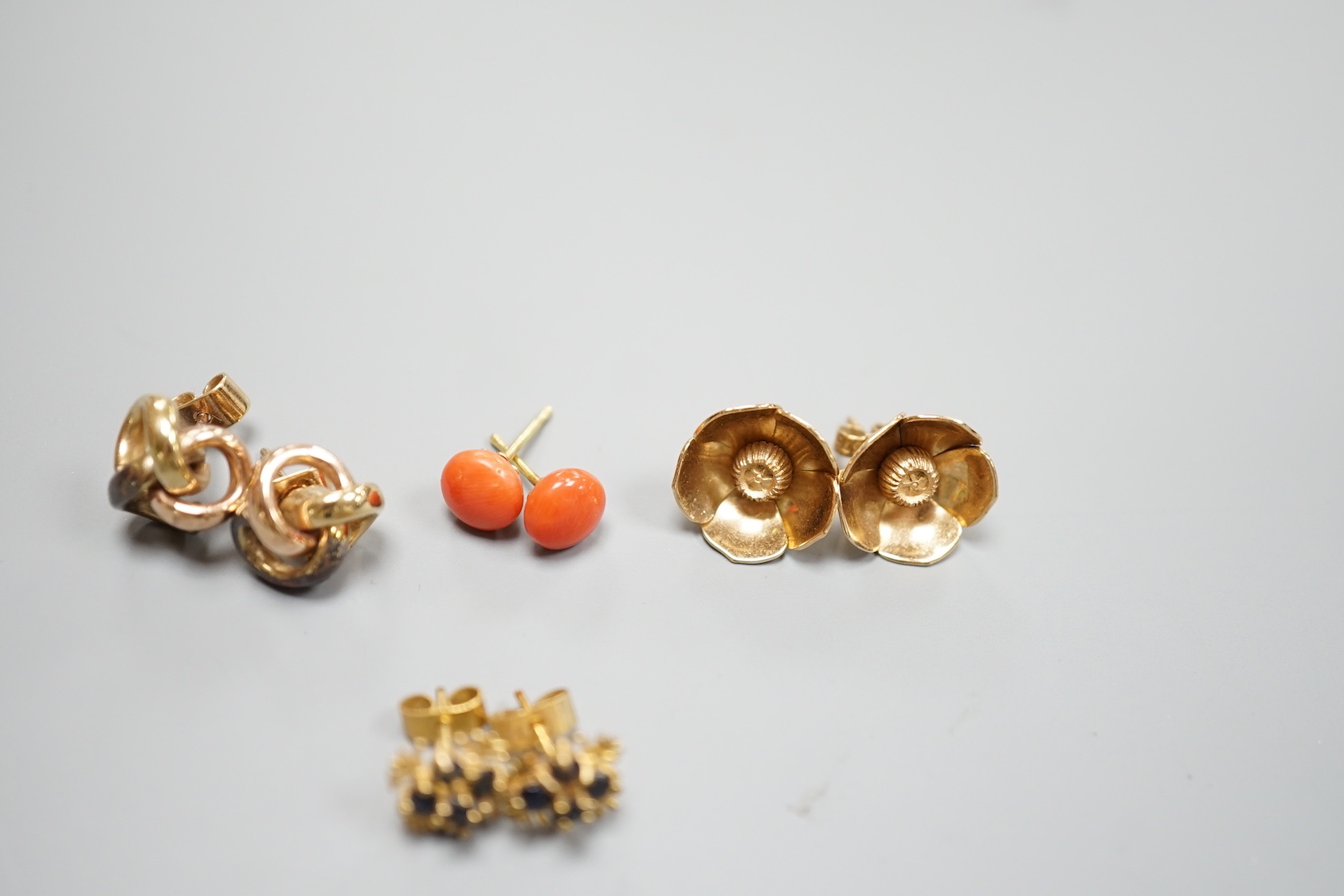 A pair of 750 yellow metal and coral bead ear studs, gross weight 1.8 grams and three pairs of modern 9ct earrings including knot and gem set, gross weight 12.2 grams.